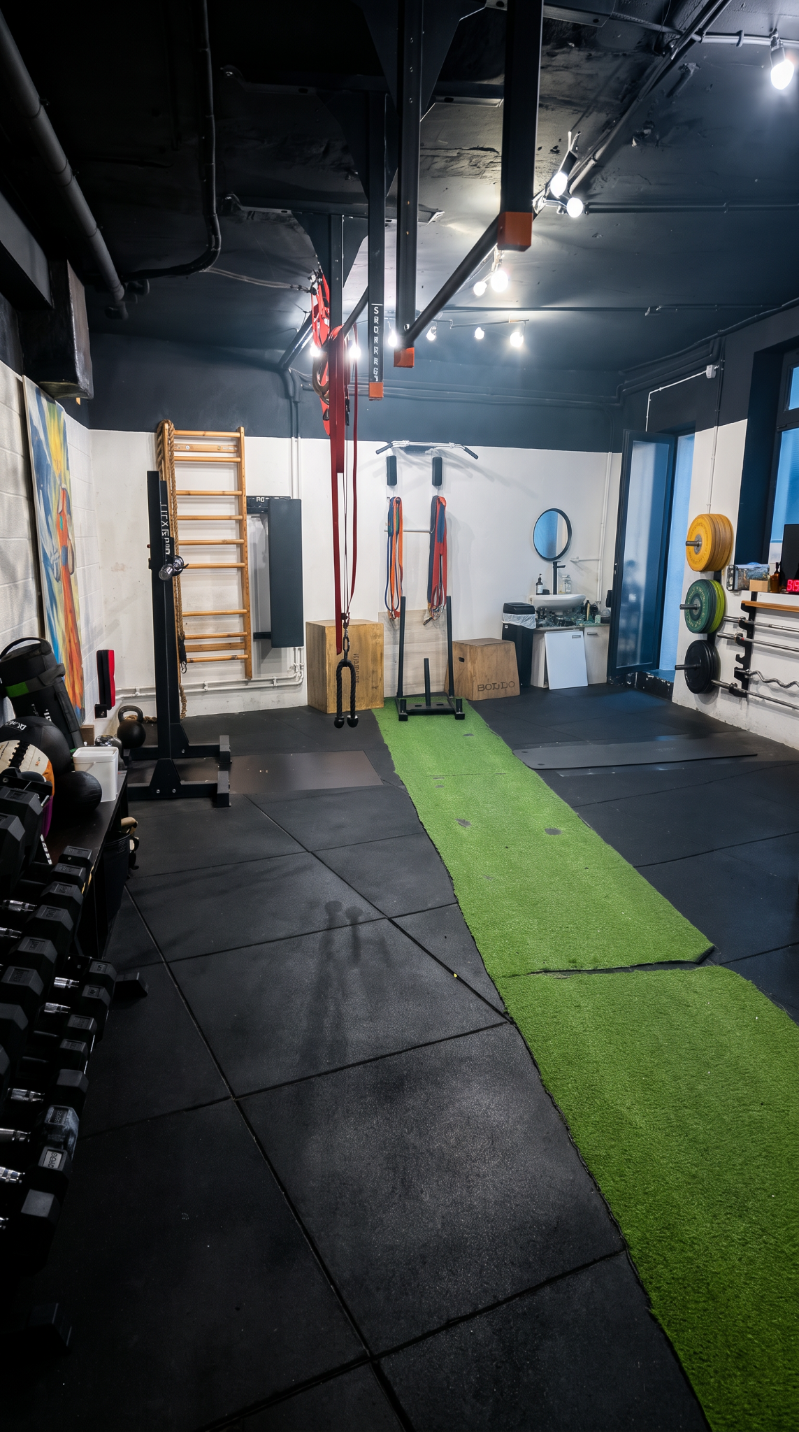 Inside the Numidia Coaching studio, with training equipment and a green exercise lane